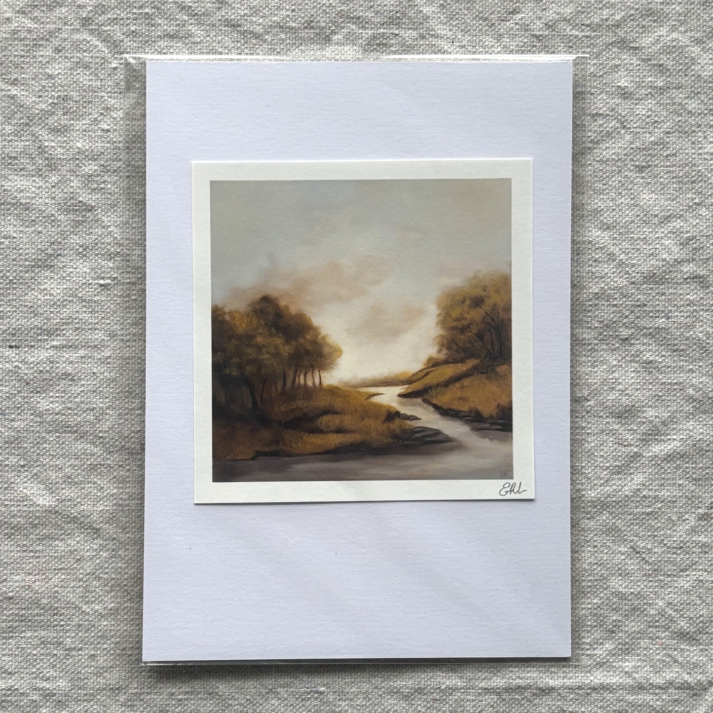 small landscape print on a textured gray surface