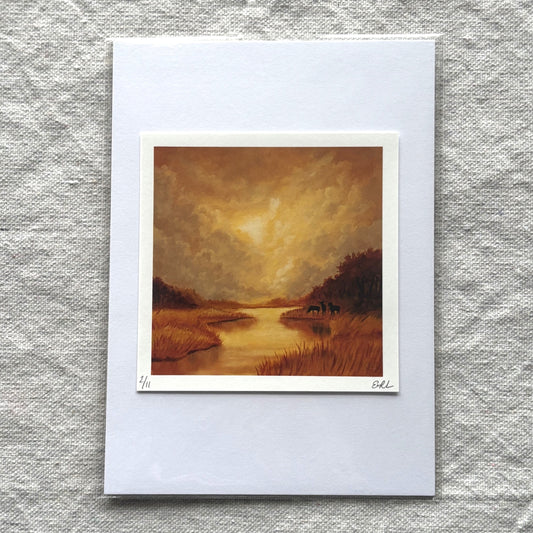 landscape print of a sunset over a river on a textured gray surface