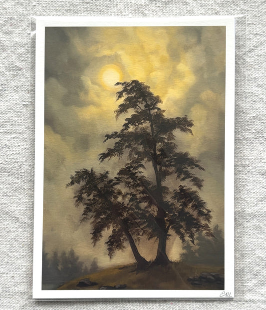 print of a lone tree under a dramatic sky with a full moon.