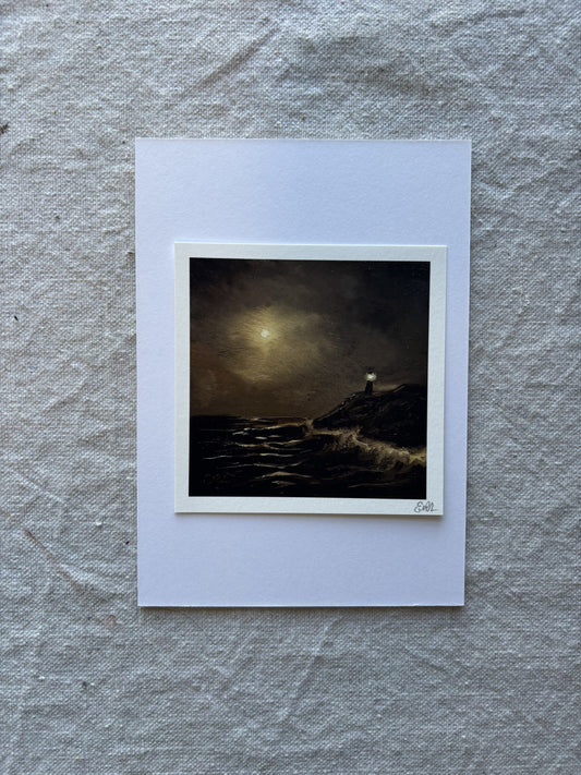 artwork of a lighthouse on a dark landscape with a large moon, displayed on a textured gray surface.